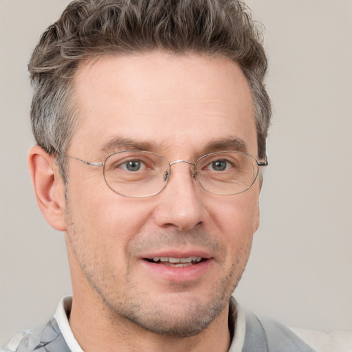 Joyful white adult male with short  brown hair and grey eyes