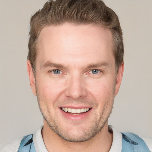 Joyful white adult male with short  brown hair and grey eyes