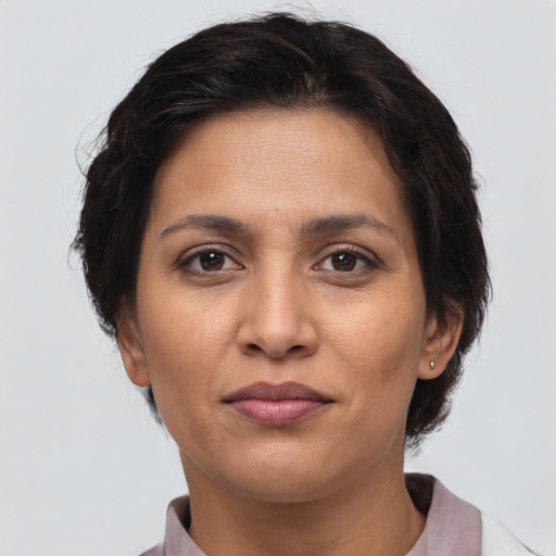 Joyful latino adult female with short  brown hair and brown eyes