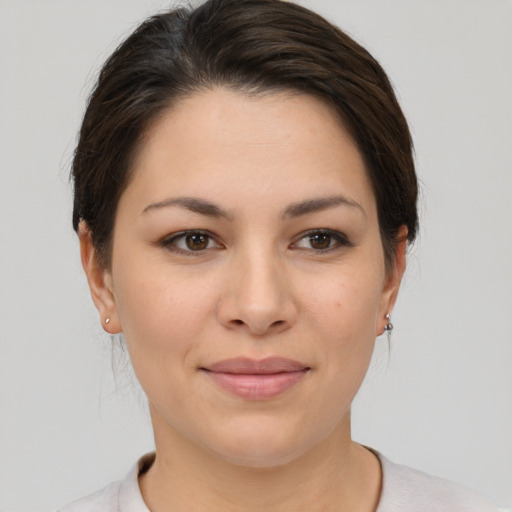 Joyful asian young-adult female with short  brown hair and brown eyes