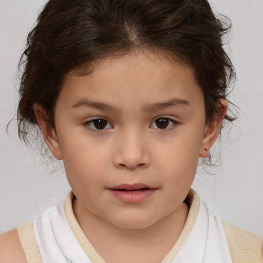 Joyful white child female with medium  brown hair and brown eyes