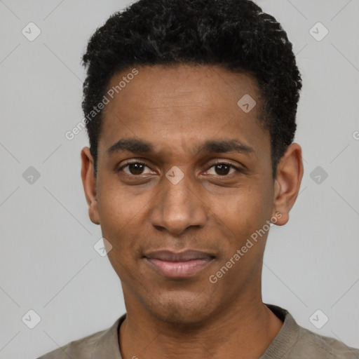 Joyful black young-adult male with short  black hair and brown eyes