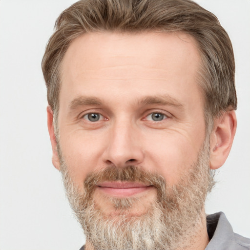 Joyful white adult male with short  brown hair and grey eyes