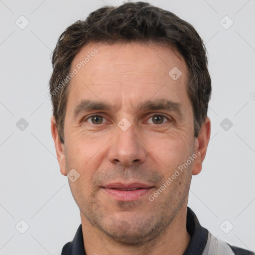 Joyful white adult male with short  brown hair and brown eyes