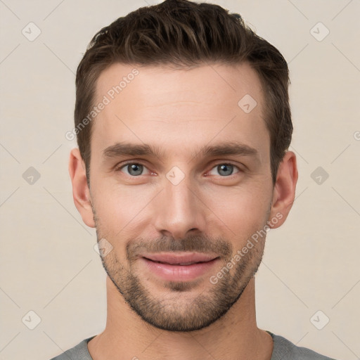 Joyful white young-adult male with short  brown hair and grey eyes