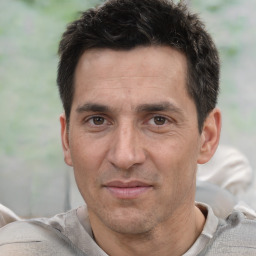 Joyful white adult male with short  black hair and brown eyes