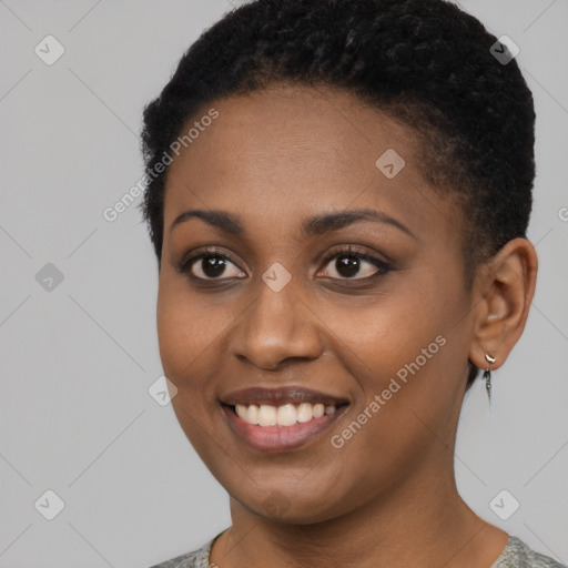 Joyful black young-adult female with short  brown hair and brown eyes