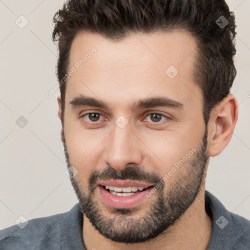 Joyful white young-adult male with short  brown hair and brown eyes