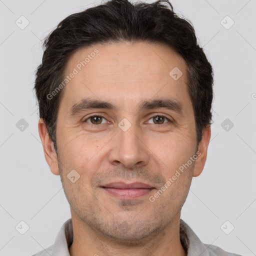 Joyful white adult male with short  brown hair and brown eyes