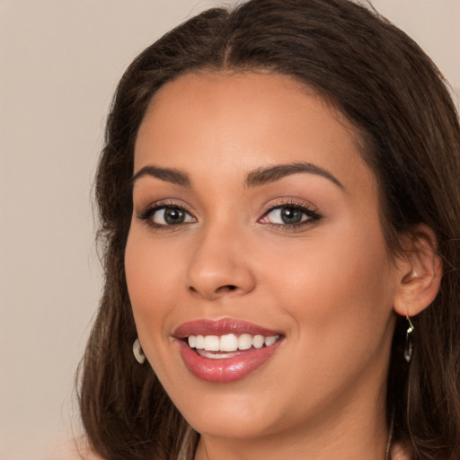 Joyful white young-adult female with long  brown hair and brown eyes