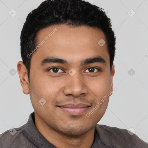 Joyful latino young-adult male with short  brown hair and brown eyes