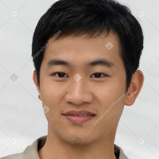 Joyful asian young-adult male with short  brown hair and brown eyes