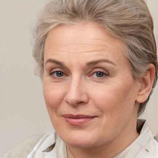 Joyful white middle-aged female with medium  brown hair and brown eyes