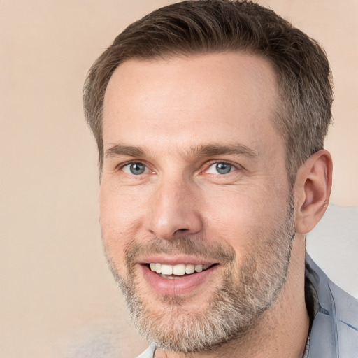 Joyful white adult male with short  brown hair and grey eyes