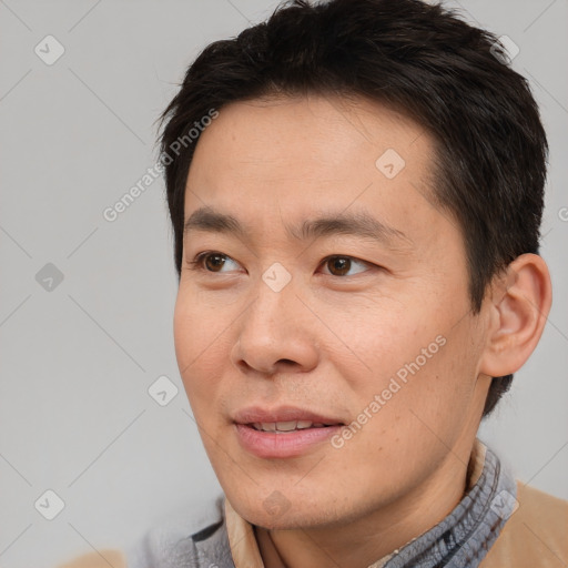 Joyful white adult male with short  brown hair and brown eyes