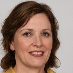 Joyful white adult female with medium  brown hair and grey eyes