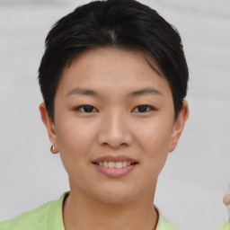 Joyful asian young-adult female with short  brown hair and brown eyes