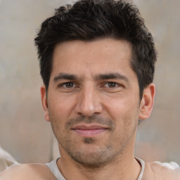 Joyful white adult male with short  black hair and brown eyes