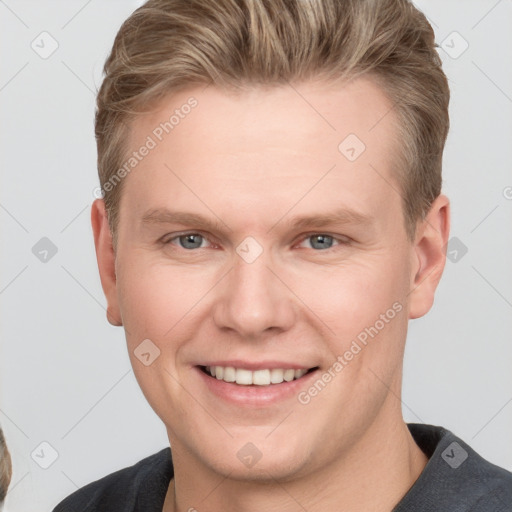 Joyful white young-adult male with short  brown hair and grey eyes