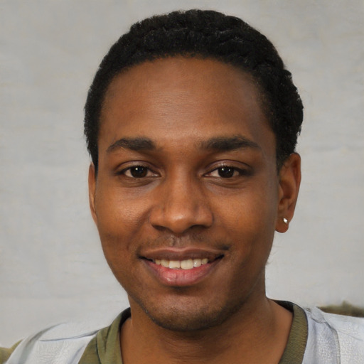 Joyful black young-adult male with short  black hair and brown eyes