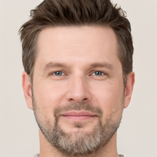 Joyful white adult male with short  brown hair and grey eyes