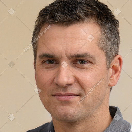 Joyful white adult male with short  brown hair and brown eyes