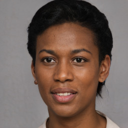Joyful black young-adult female with short  black hair and brown eyes