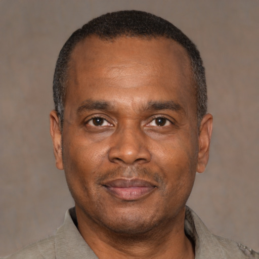 Joyful latino adult male with short  black hair and brown eyes