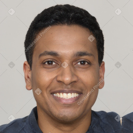 Joyful latino young-adult male with short  brown hair and brown eyes