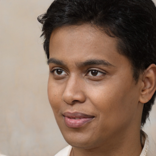 Joyful black young-adult male with short  brown hair and brown eyes