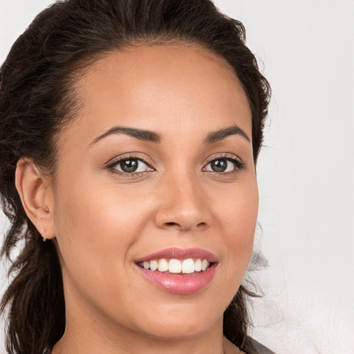 Joyful white young-adult female with long  brown hair and brown eyes