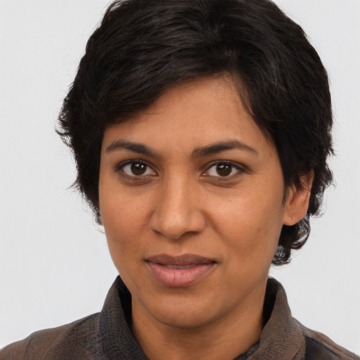 Joyful latino adult female with medium  brown hair and brown eyes