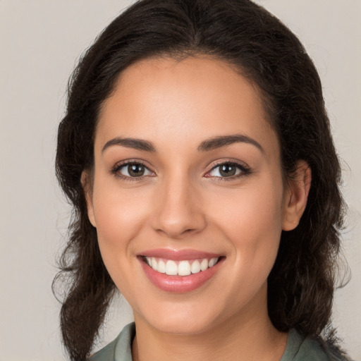 Joyful white young-adult female with long  brown hair and brown eyes