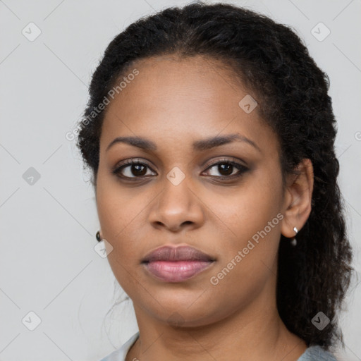 Joyful black young-adult female with long  black hair and brown eyes