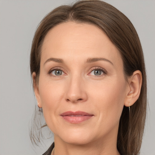 Joyful white adult female with medium  brown hair and grey eyes