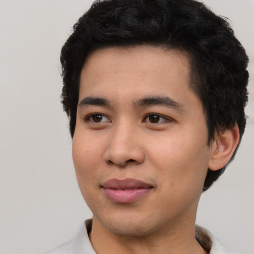 Joyful asian young-adult male with short  black hair and brown eyes