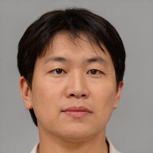 Neutral asian adult male with short  brown hair and brown eyes