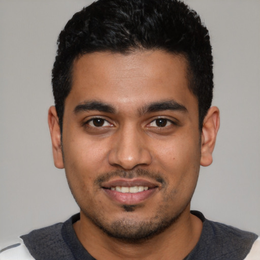 Joyful latino young-adult male with short  black hair and brown eyes