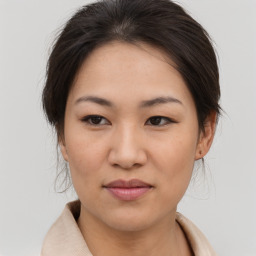 Joyful asian young-adult female with medium  brown hair and brown eyes