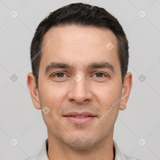 Joyful white young-adult male with short  brown hair and brown eyes