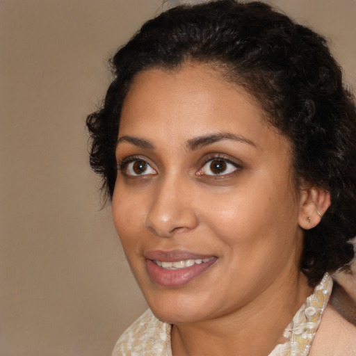 Joyful black young-adult female with medium  brown hair and brown eyes