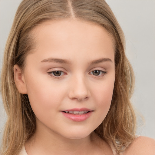 Joyful white child female with long  brown hair and brown eyes