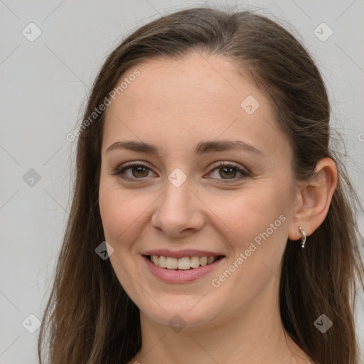 Joyful white young-adult female with long  brown hair and grey eyes