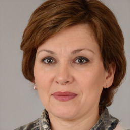 Joyful white adult female with medium  brown hair and brown eyes