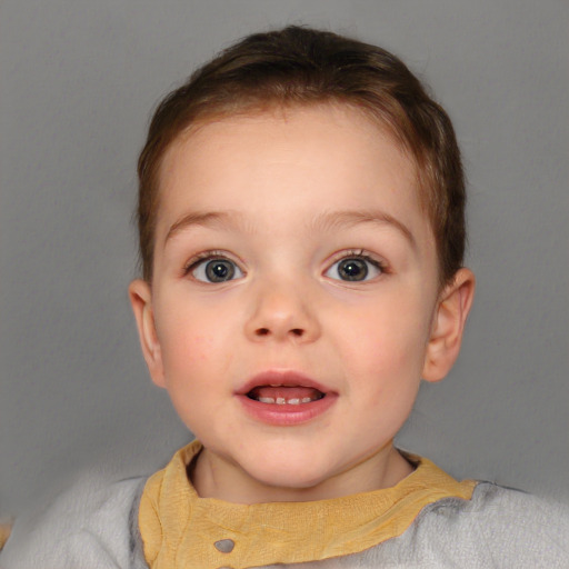 Joyful white child female with short  brown hair and blue eyes