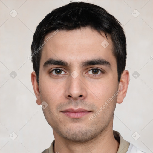 Joyful white young-adult male with short  black hair and brown eyes