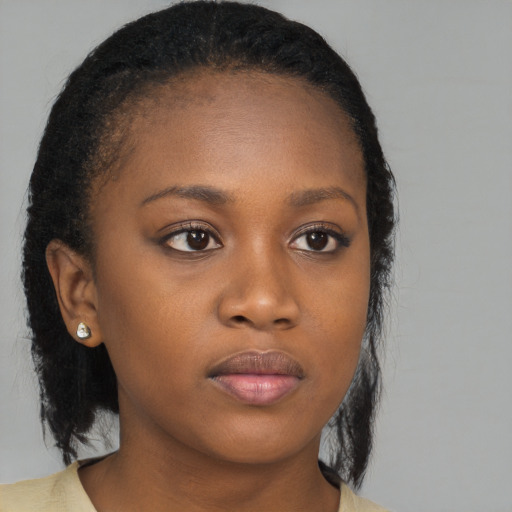 Neutral black young-adult female with medium  brown hair and brown eyes