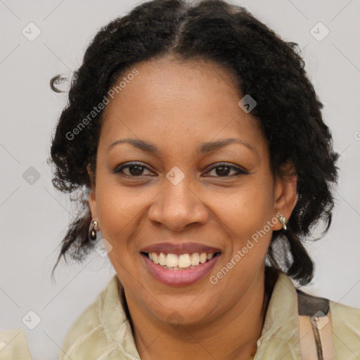 Joyful black adult female with long  brown hair and brown eyes