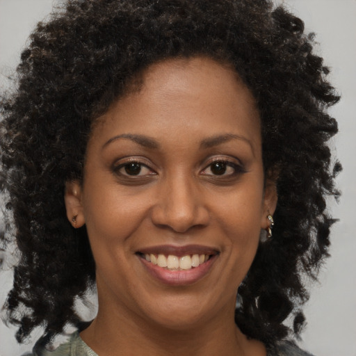 Joyful black young-adult female with medium  brown hair and brown eyes