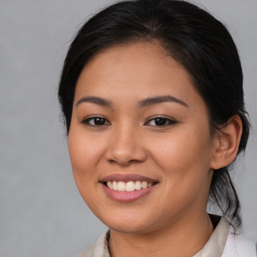 Joyful asian young-adult female with medium  brown hair and brown eyes